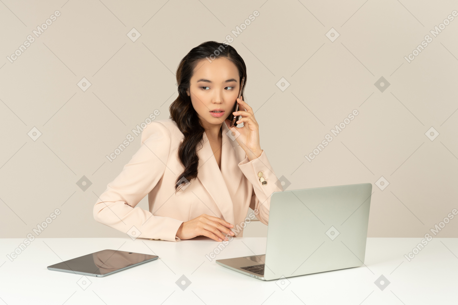 Asian office employee involved in phone conversation