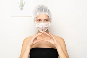 Woman in mask holding syringe