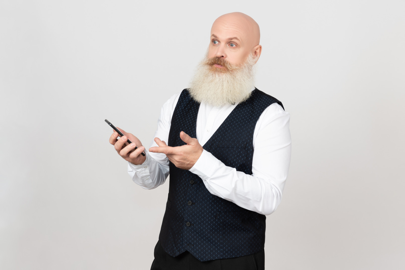 Aged man holding phone and looking little surprised