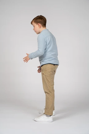 A young boy in a blue shirt and khaki pants