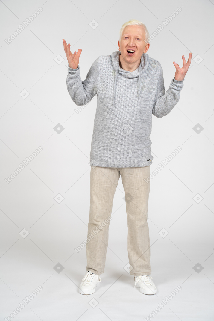 Man standing with raised arms and open mouth