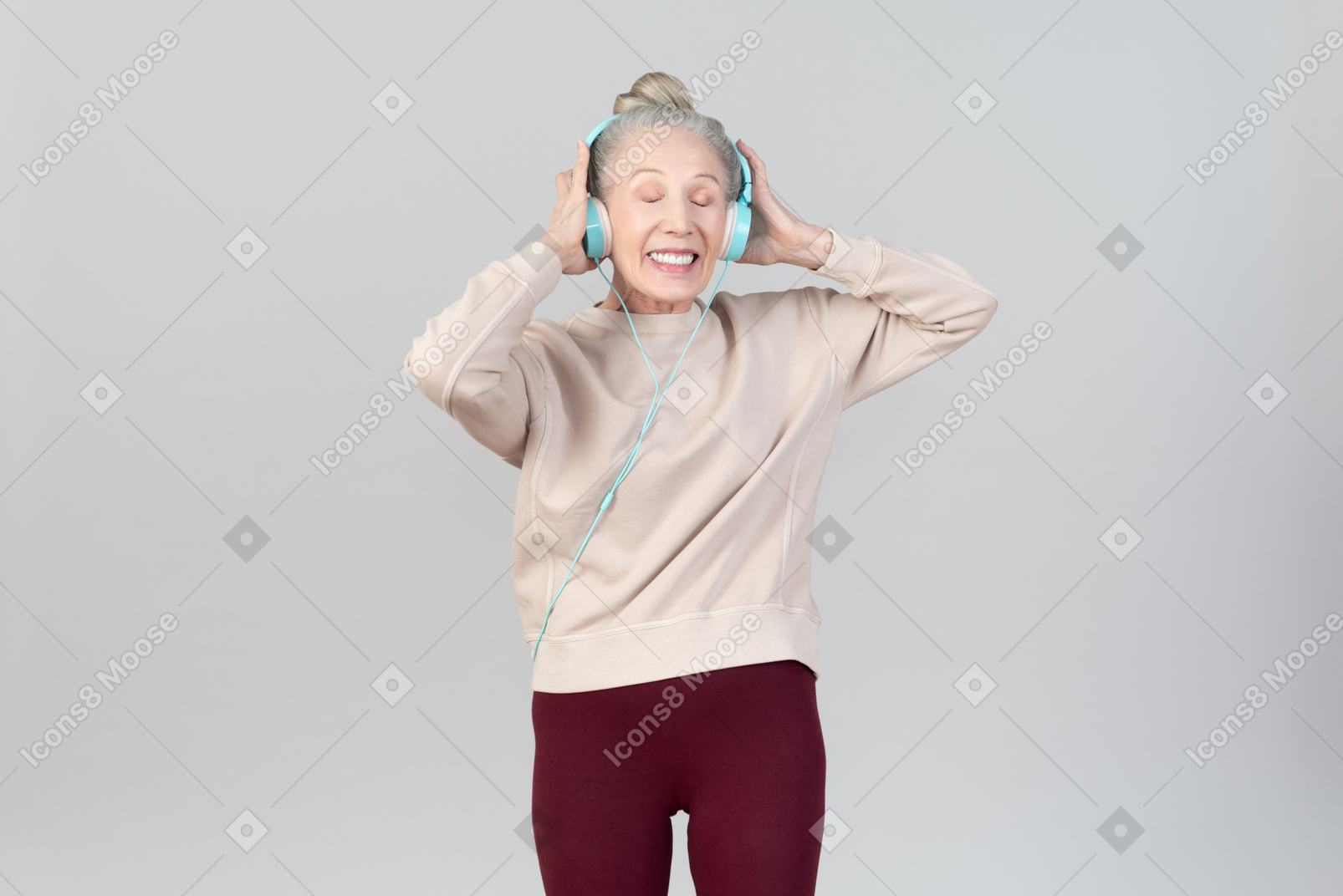 Good looking older woman listening to music in headphones
