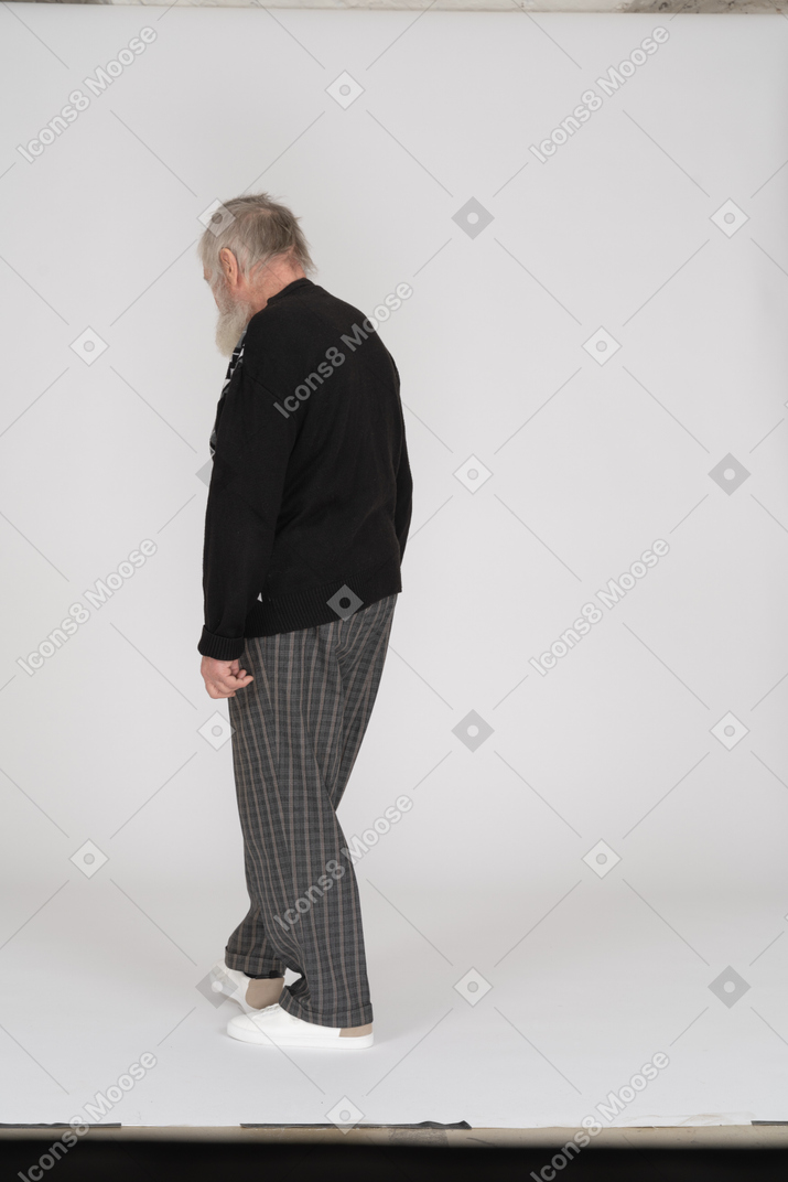 Anciano parado de espaldas a la cámara