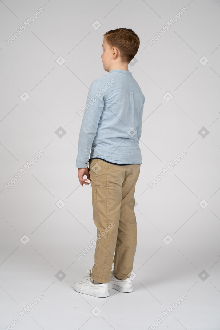 Boy in casual clothes standing still