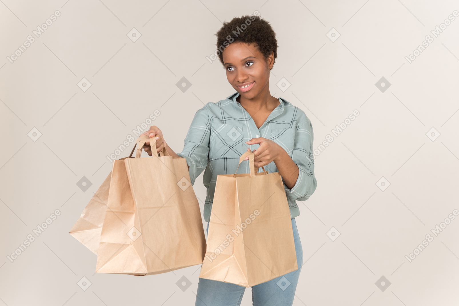 Smiling young afro woman holding paper bags