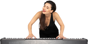 Front view of a smiling young lady in black dress leaning on the piano