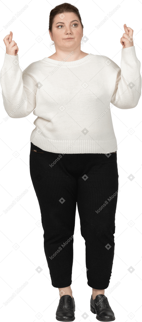Front view of a plump woman in casual clothes crossing fingers