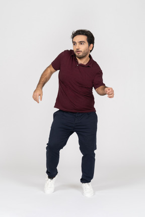Startled man in casual clothes dancing