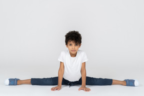 A boy doing split exercise