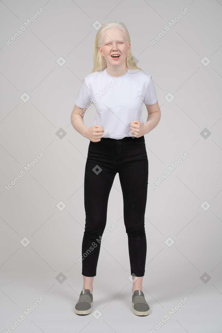 Young girl standing with fists and open mouth