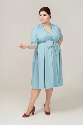 Front view of a woman in blue dress gesturing