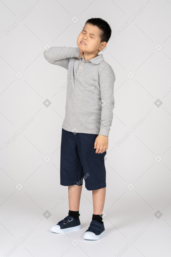 Boy in pain holding neck