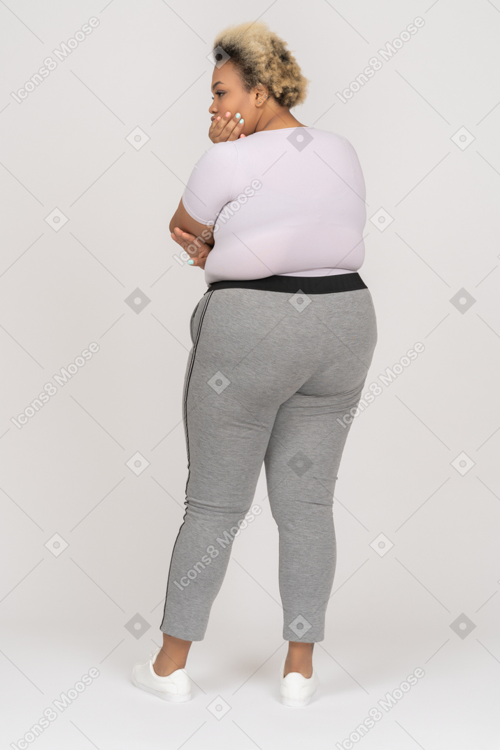 Thoughtful black woman posing back to camera