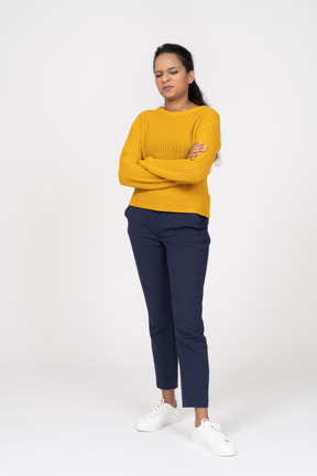 Front view of a girl in casual clothes posing with crossed arms