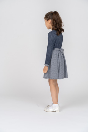 Three-quarter back view of a girl standing