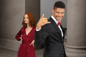 A man in a suit and a woman in a red dress