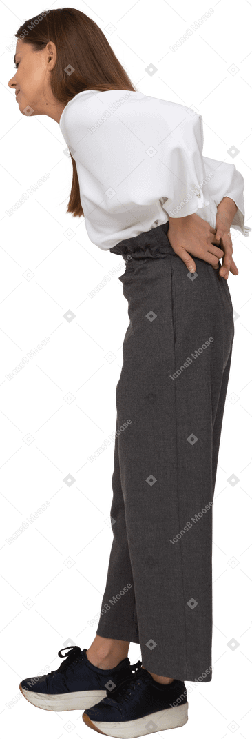 Side view of a young lady in office clothing with back pain