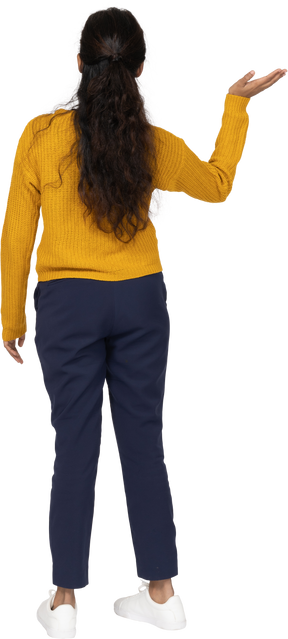Rear view of a girl in casual clothes waving