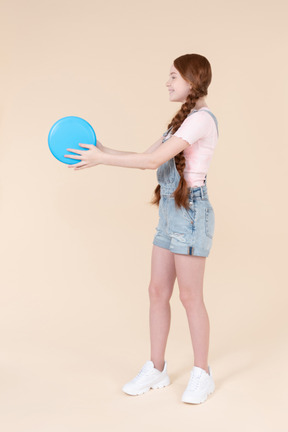 Teenage girl holding frisbee