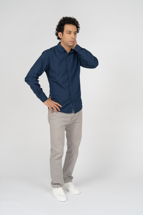 Front view of a man in casual clothes wondering