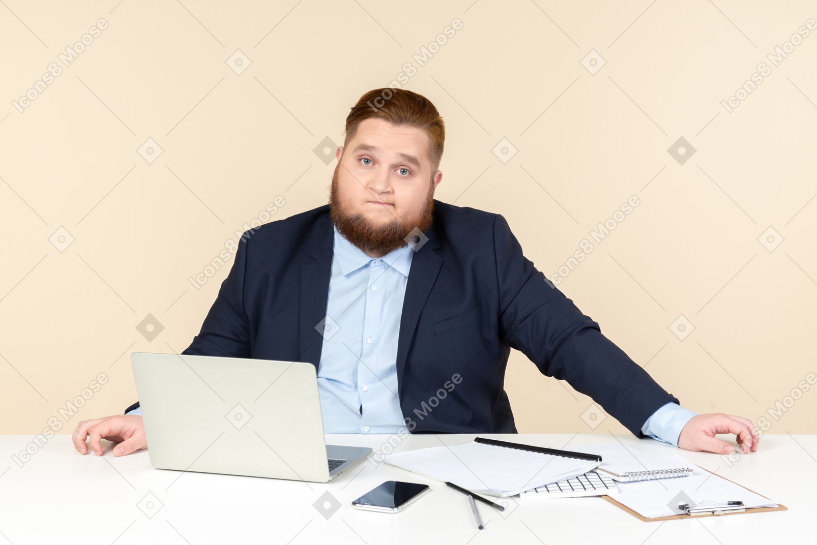 Preoccupied young overweight office worker sitting at the office desk