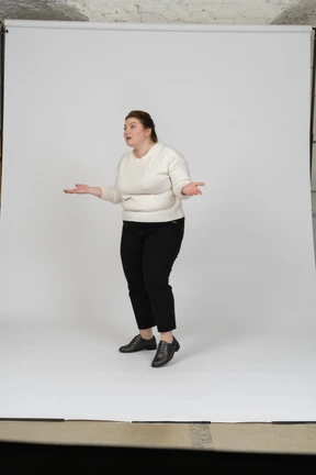 Side view of a plump woman in casual clothes gesturing