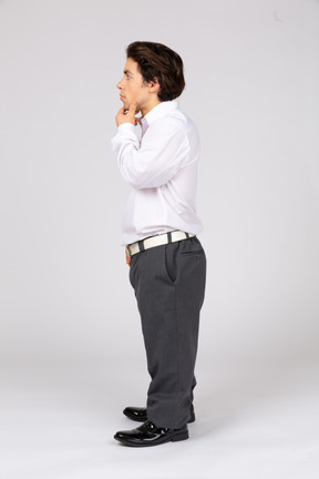 Side view of a male office worker thinking