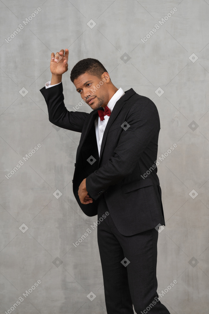 Man in black suit posing