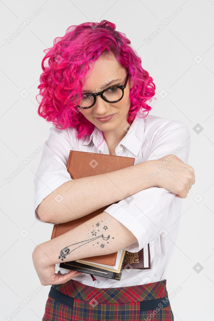 Student girl in eyeglasses holding books