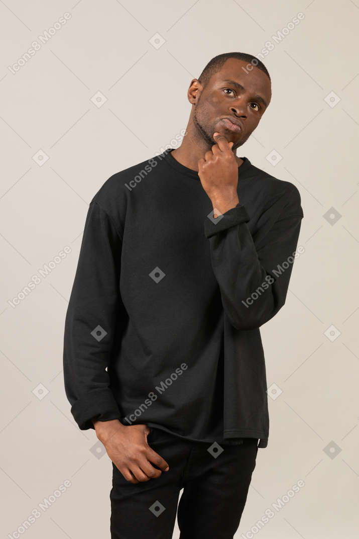 Thoughtful man with hand in pocket and hand on chin