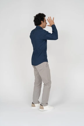 Side view of a man in casual clothes gesturing