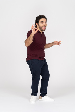 Cheerful man making ok gesture