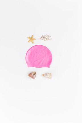 Face imitation made of shells and pink swimming cap