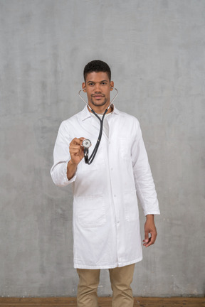 Male doctor using a stethoscope