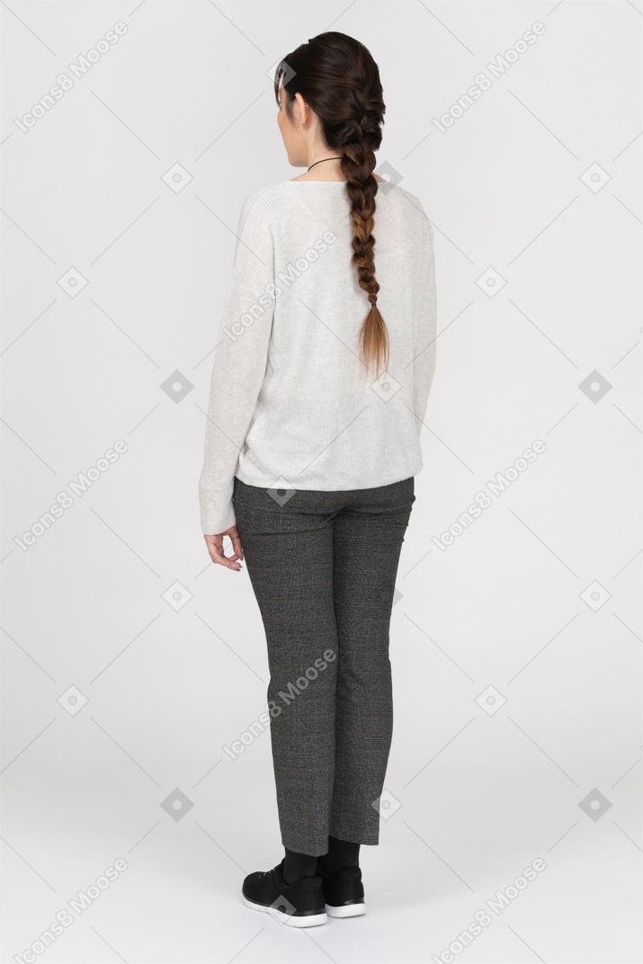 Slim caucasian female with long brown hair posing back to camera isolated over white background