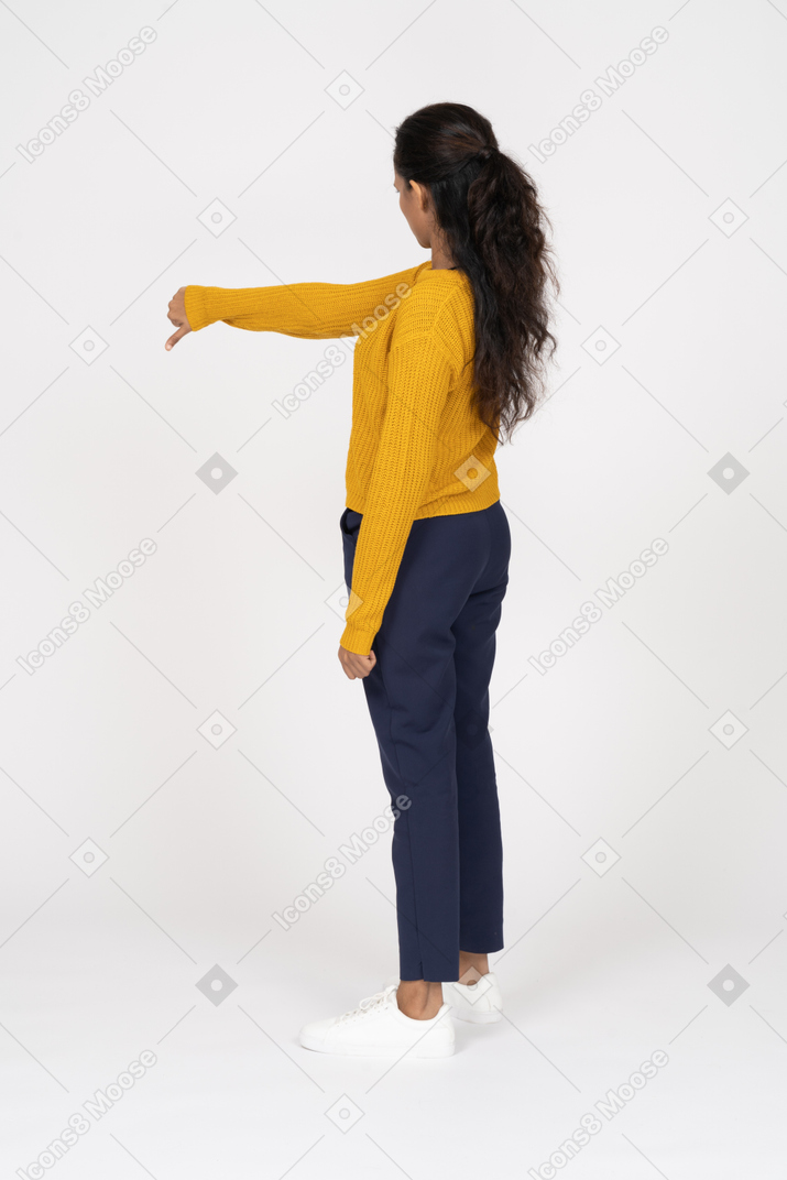 Side view of a girl in casual clothes showing thumb down
