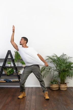 Handsome athletic man posing on the background of the apartment