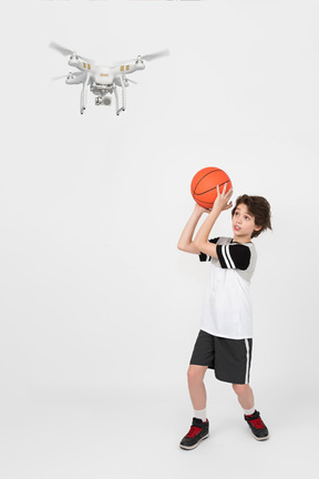 Boy trying to knock down a drone with a ball
