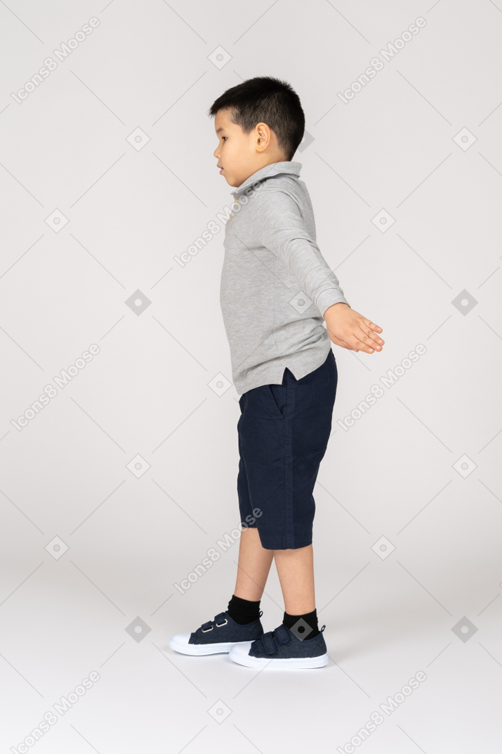 Boy with spread arms in profile