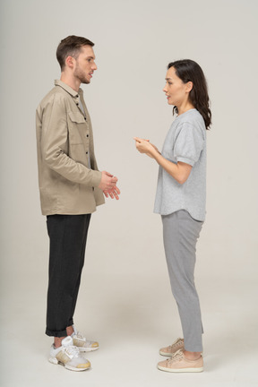 Side view of young couple speaking to each other