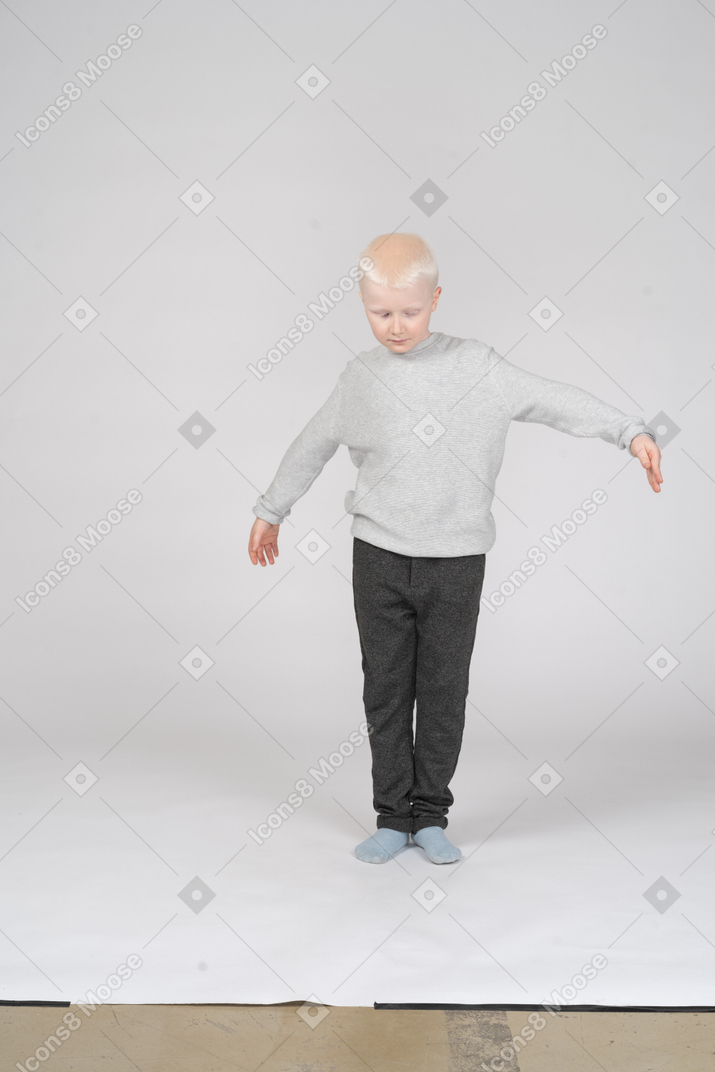 Front view of a little boy spreading his arms
