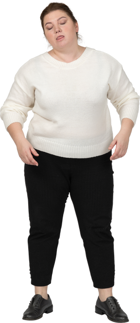Front view of a plus size woman in casual clothes making faces