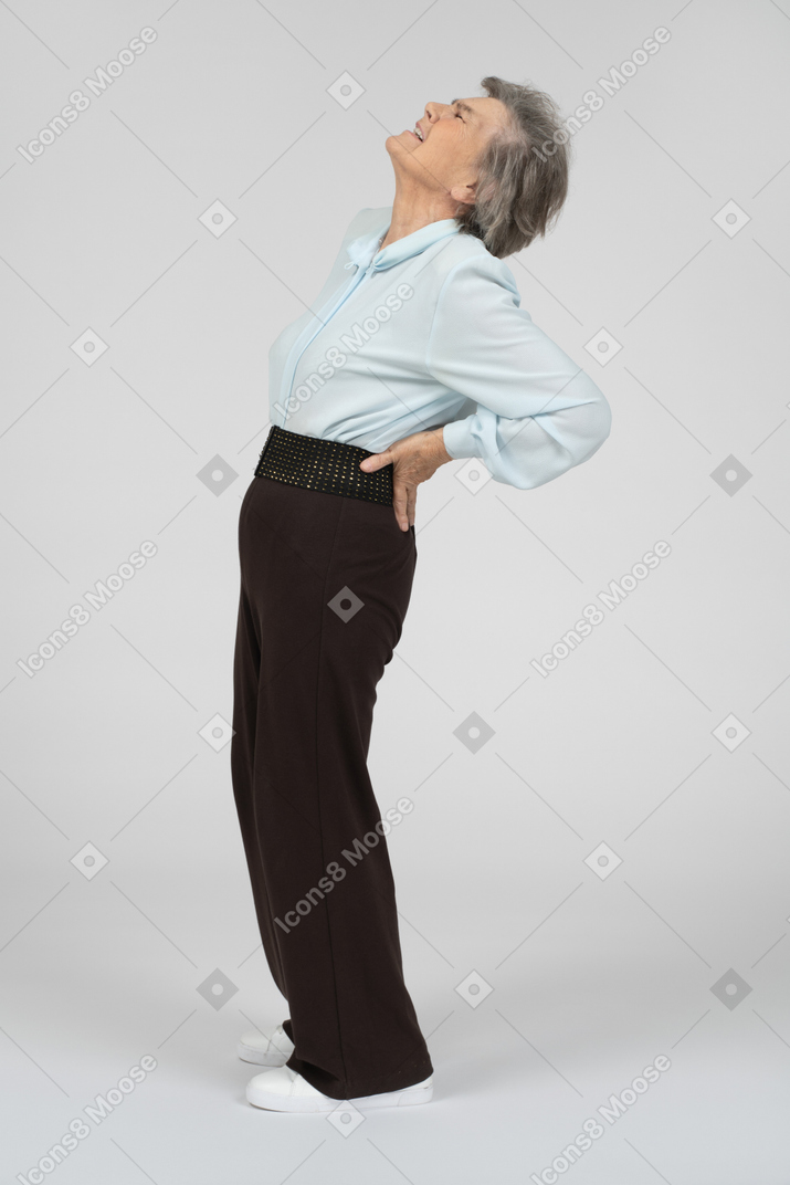Old woman suffering from back pain