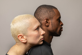 Young woman leaning her head on man's shoulder