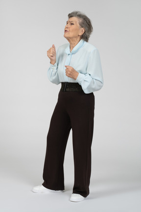 Front view of an old woman gesturing pleadingly