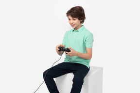 Happy teenage boy playing video games