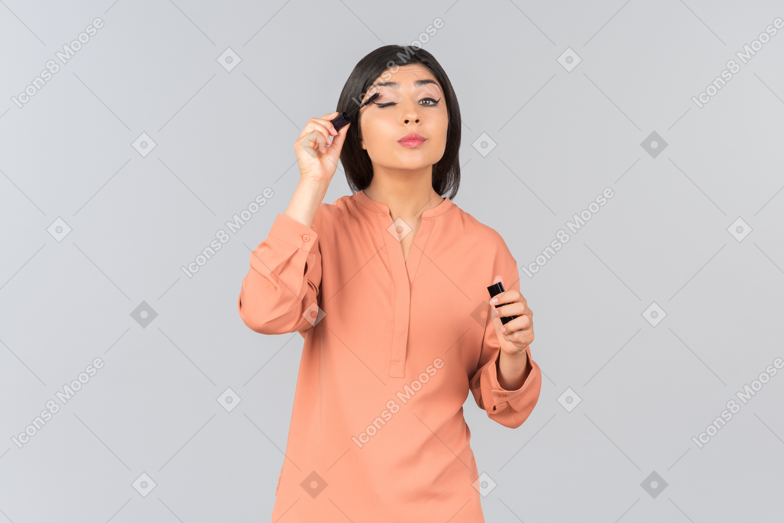 Indian woman applying mascara