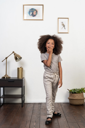 Good looking girl kid posing on the apartment background