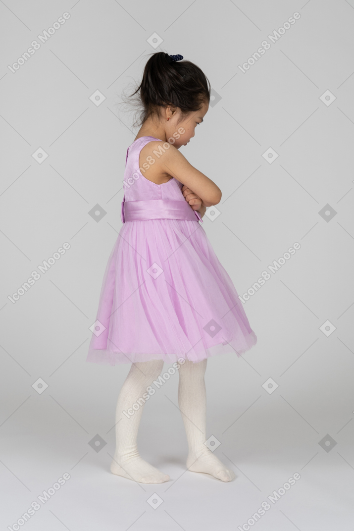 Asian girl in pink dress pouting with crossed hands