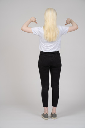 Back view of a young girl with two thumbs down